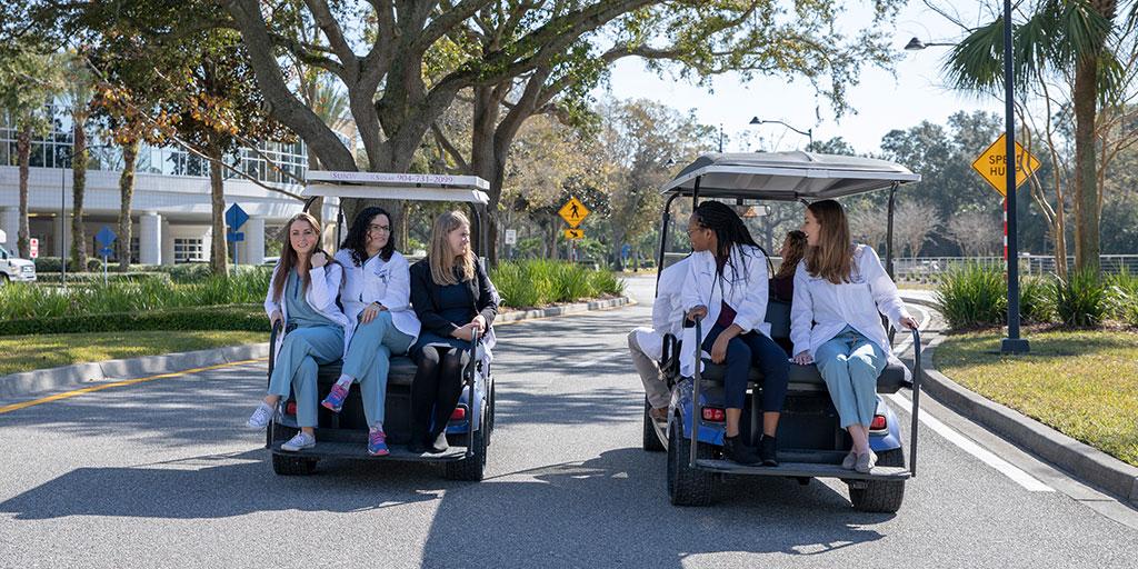 Residents riding in golf carts on Mayo Clinic's campus in Jacksonville, Florida.