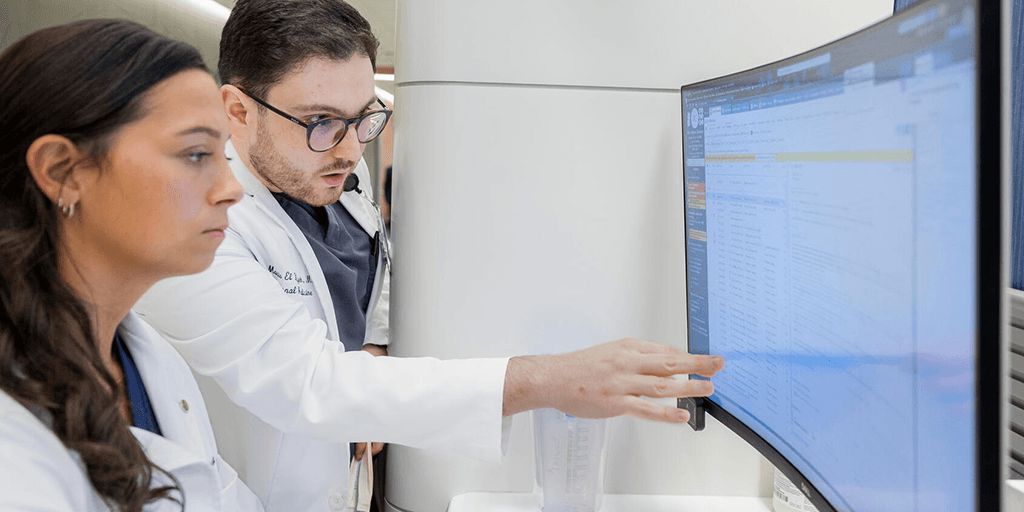 Two residents reviewing information on a computer