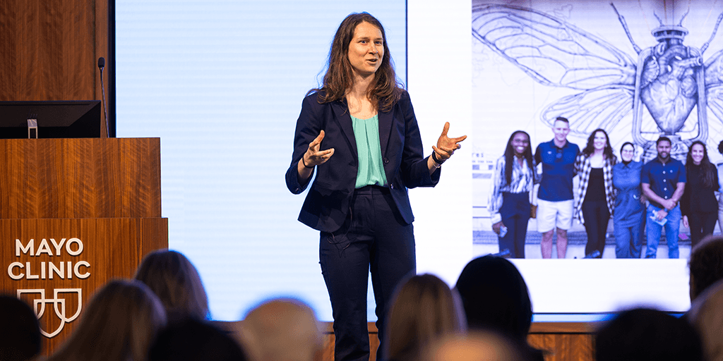 Woman presenting in front of slide show