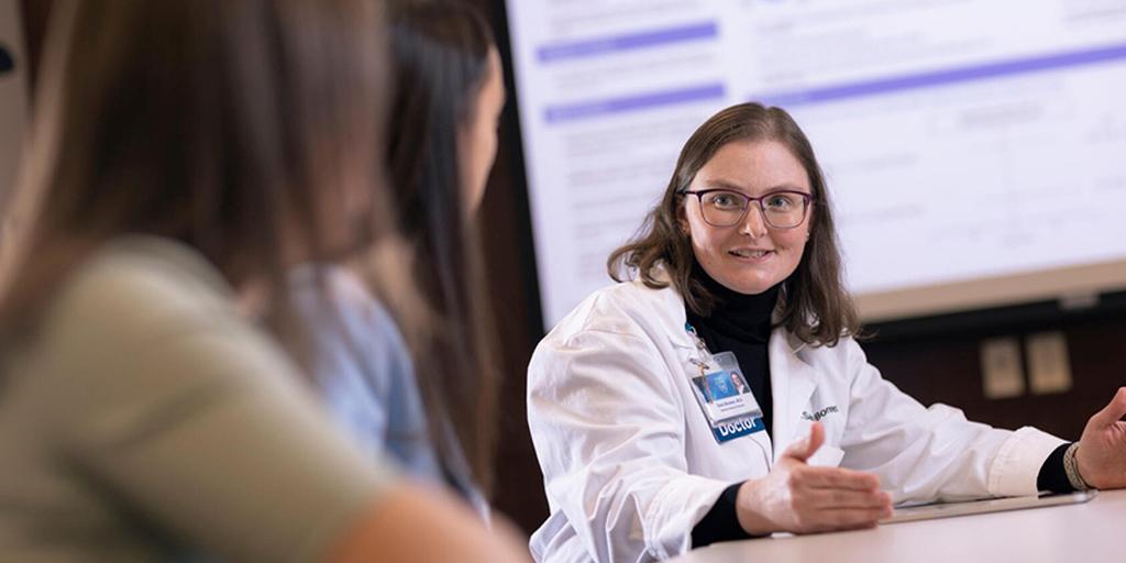An internal medicine doctor speaks to a colleague.