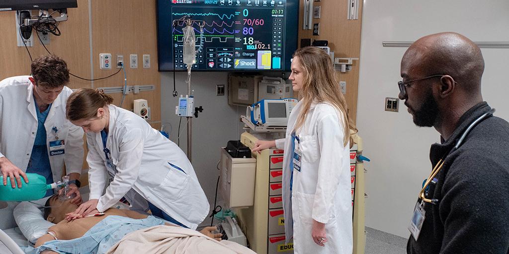 Internal medicine doctors work on a patient.