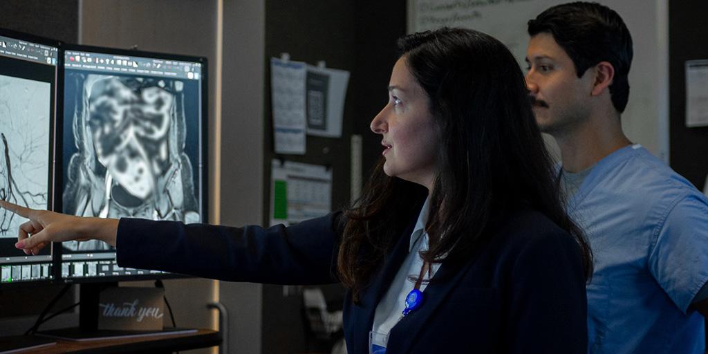 Two residents looking at images on screen.