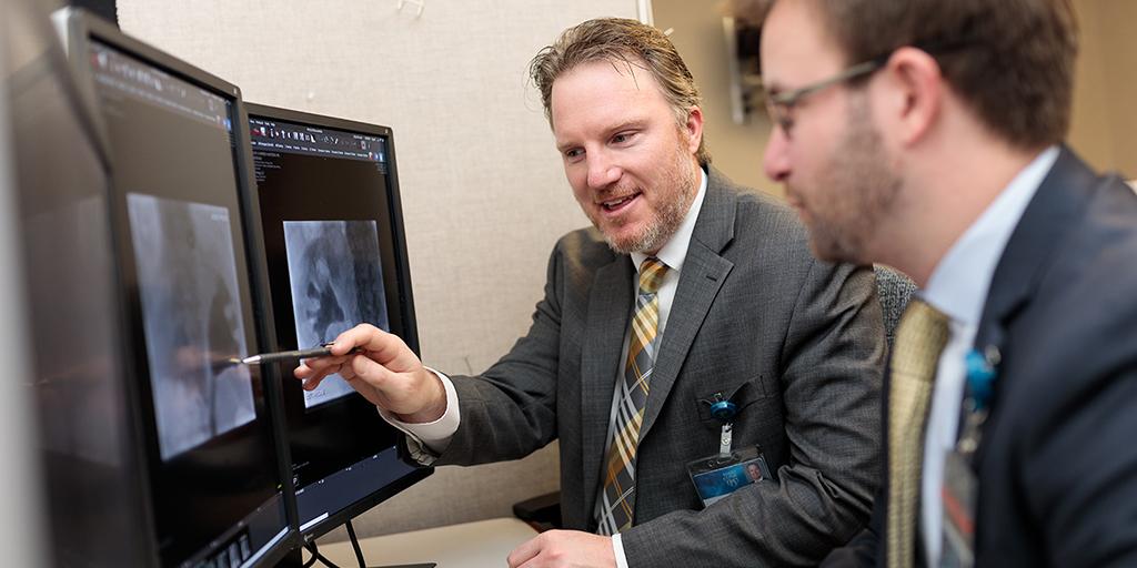 Interventional radiology resident and faculty member looking at a scan at Mayo Clinic in Rochester, Minnesota.