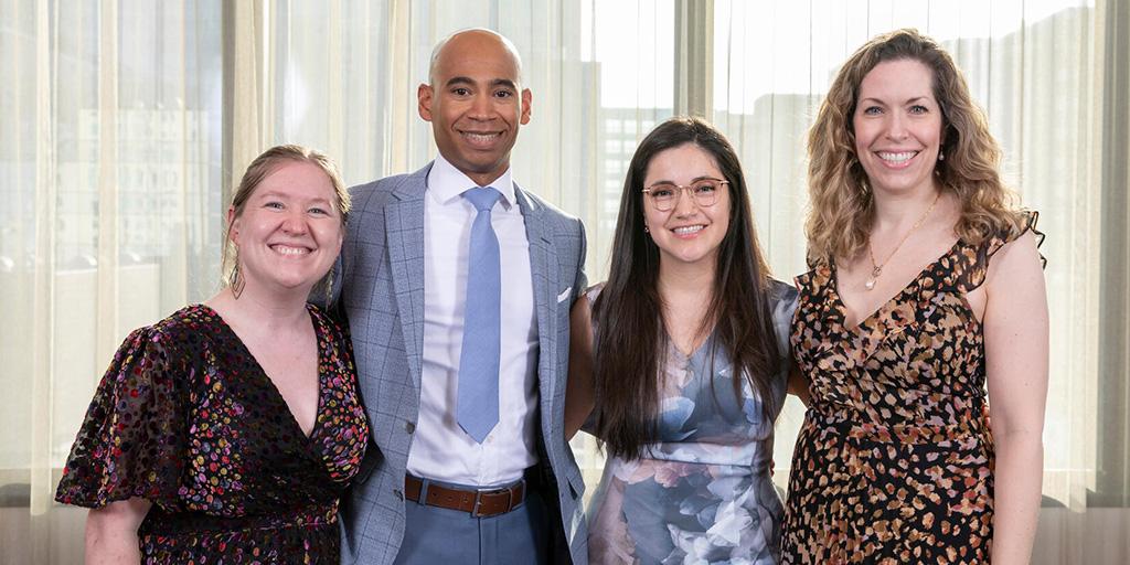 Four fellows posing for a photo at the Obstetrics and Gynecology Residency and Fellowship graduation, 2023