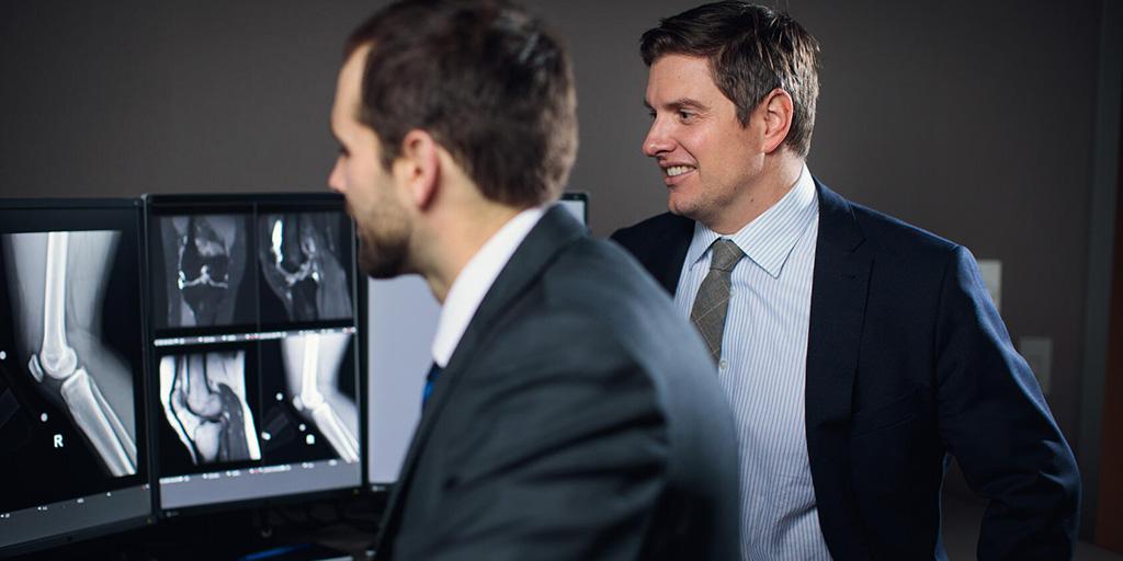 Two doctors from the Musculoskeletal Imaging Fellowship program in Rochester, Minnesota, review images at a computer station.