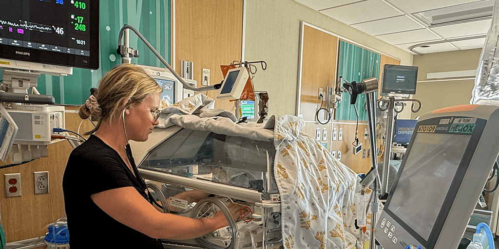 Baby in NICU being monitored by a fellow
