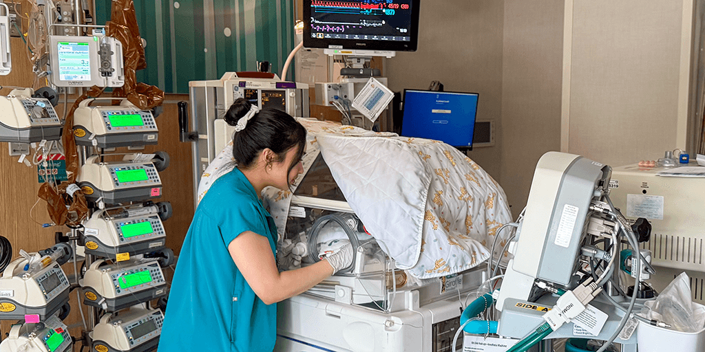Baby in NICU being monitored by a fellow