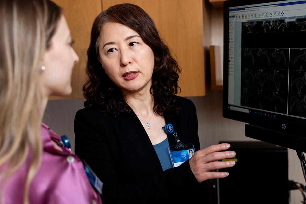 Two people from the Orthodontics Residency at Mayo Clinic in Rochester, Minnesota, discussed results while looking at a computer monitor.