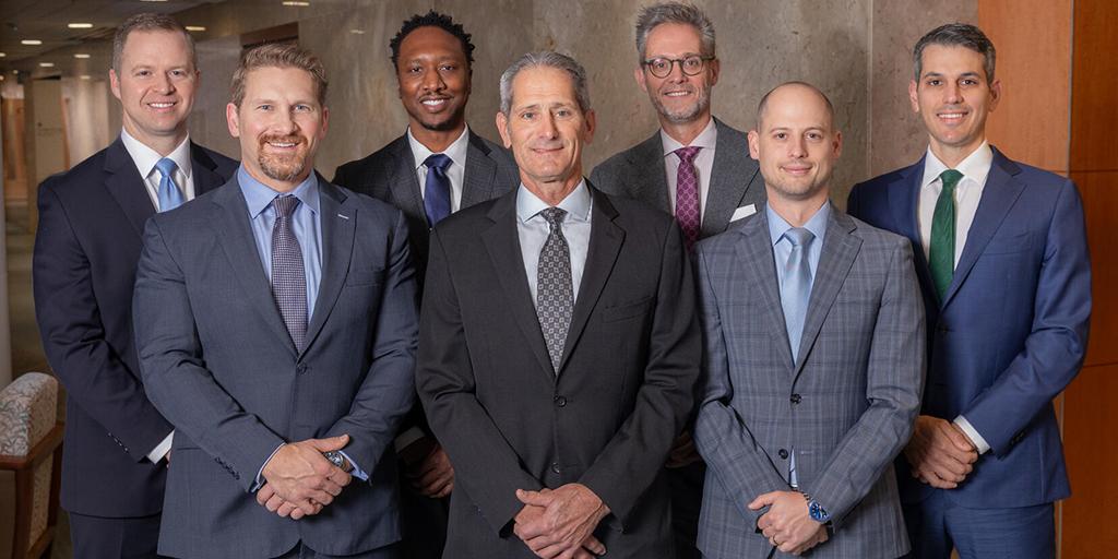 Orthopedic surgery and sports medicine specialists pose together for a group photograph.