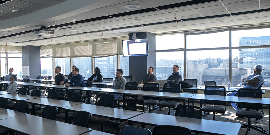 Residents in large classroom watching lecture