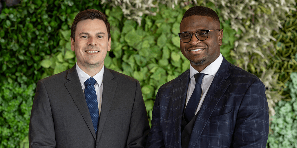 Two people from the Pain Medicine Fellowship stand for photo outside