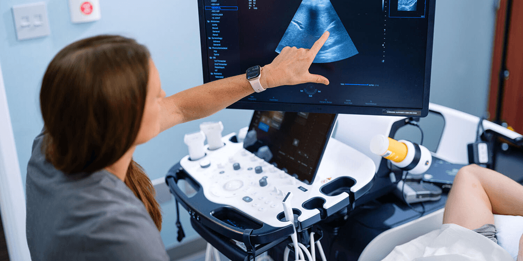 Physician performing ultrasound on patient