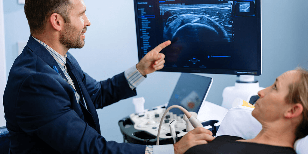 Physician performing ultrasound on patient.
