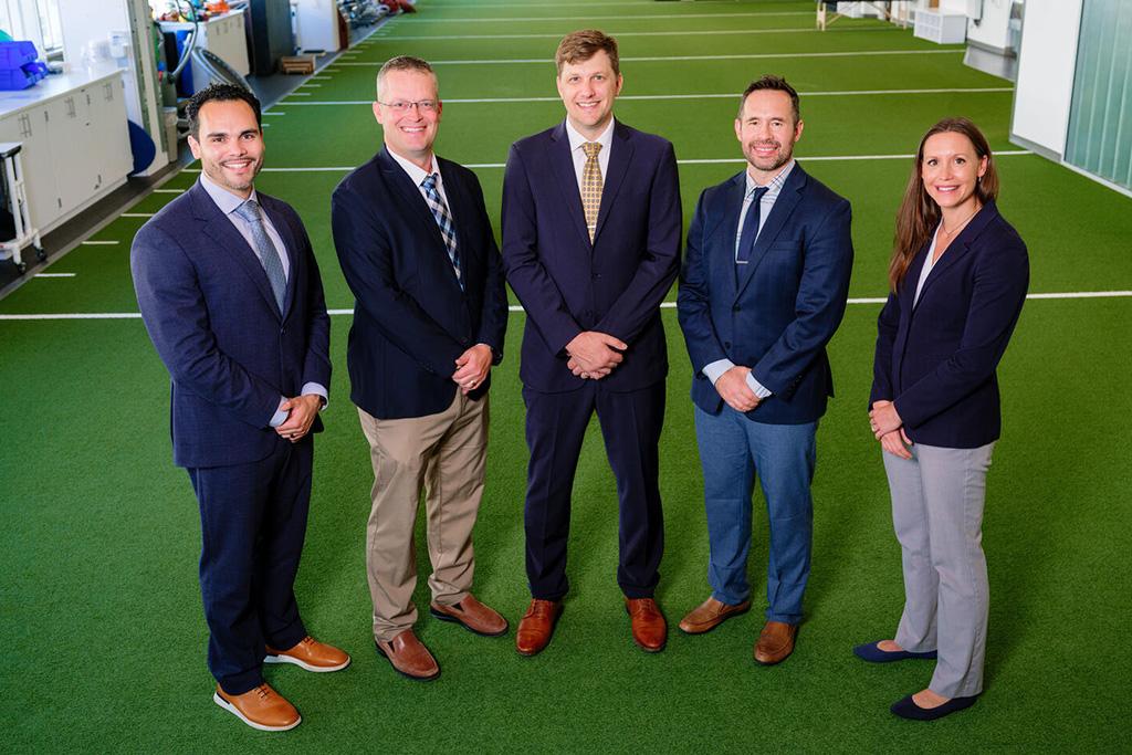 Five faculty members pose for a portrait.