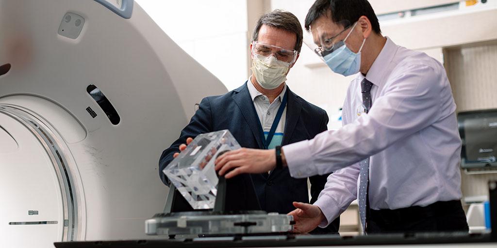 Mayo Clinic radiation oncology faculty inspect a radiotherapy instrument