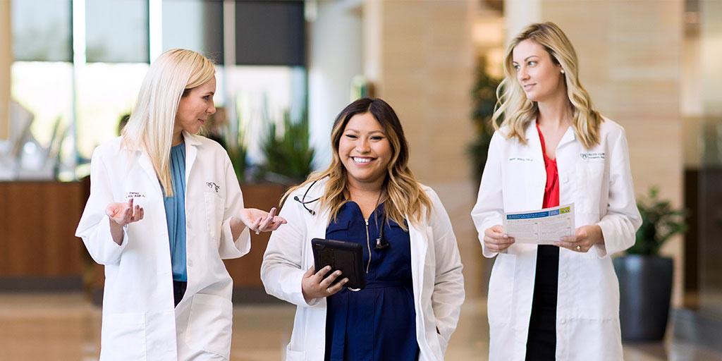Mayo Clinic trainees talking while walking in hospital