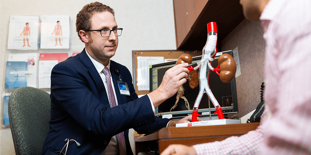 A Mayo Clinic faculty member with a model