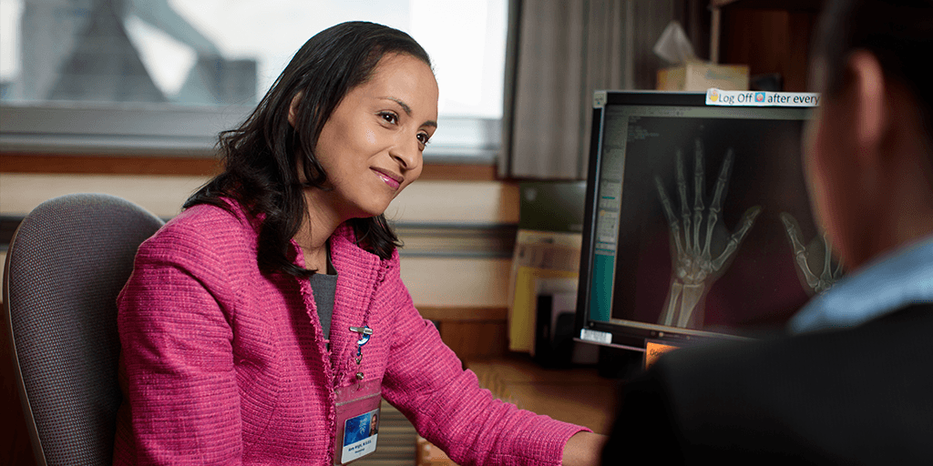A Mayo Clinic rheumatology physician with a patient