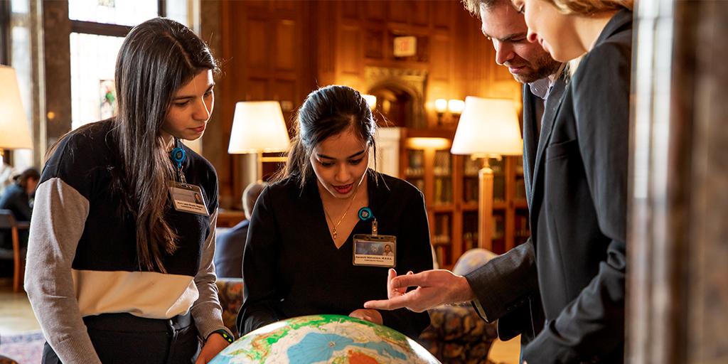 Students evaluating a globe.