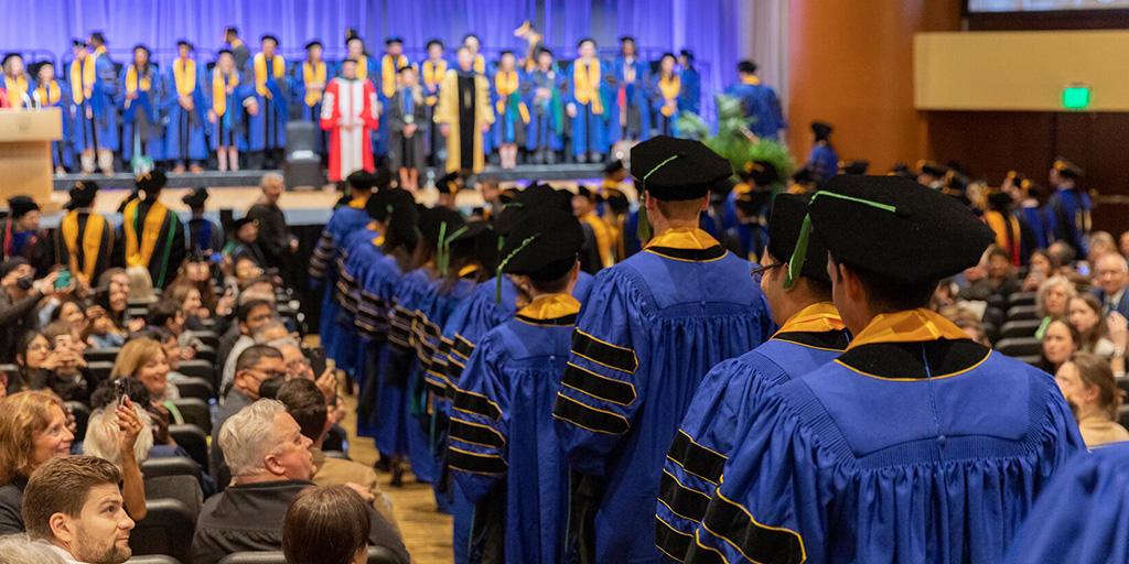 Graduating students lead a procession into the Commencement ceremony at Mayo Clinic