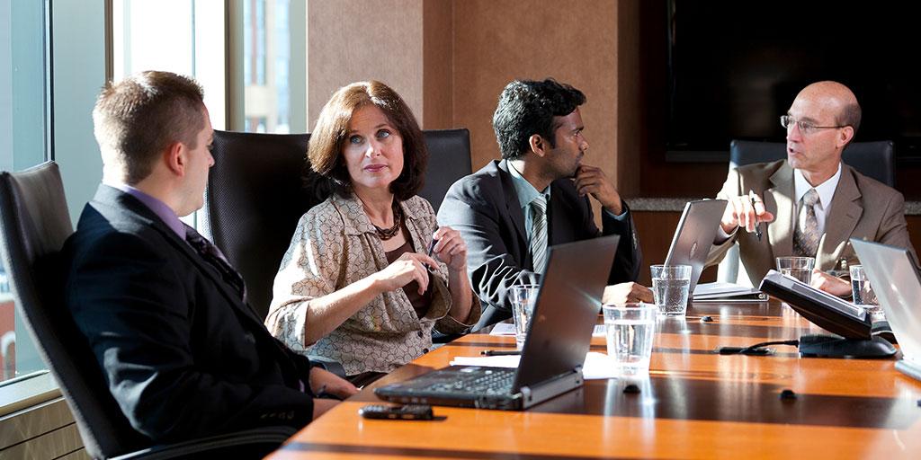 Mayo Clinic staff talking around a table