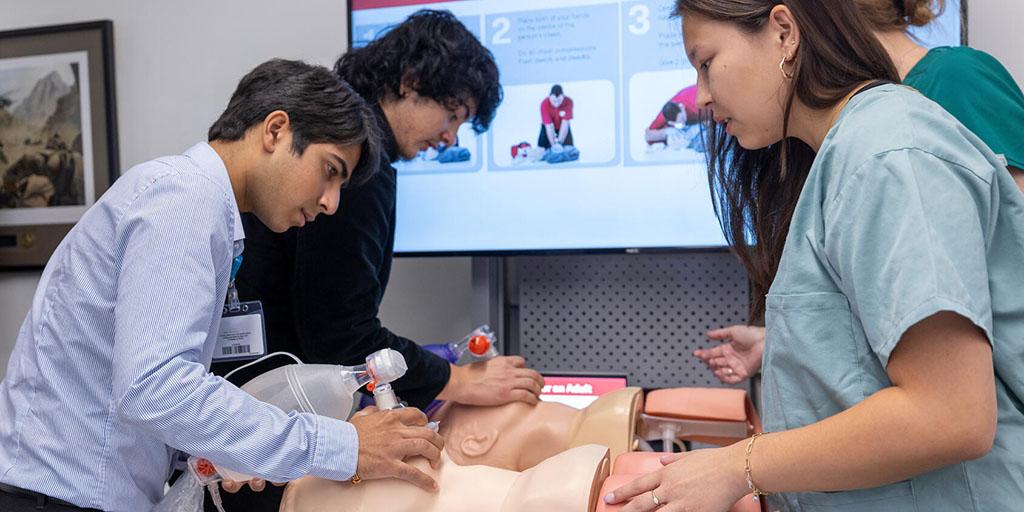 High school students in the Mayo Clinic CARES program work on a patient simulation under the direction of Mayo Clinic staff