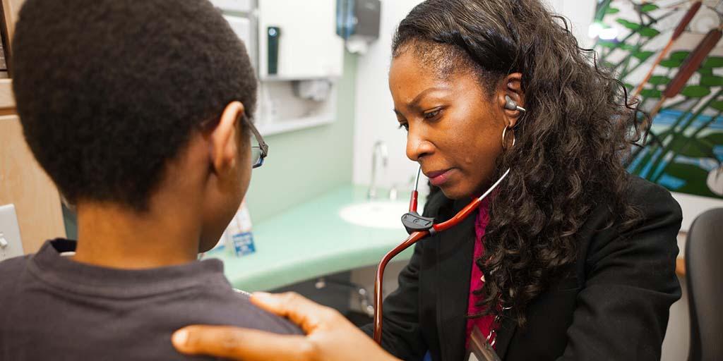 Physician examining a pediatric patient