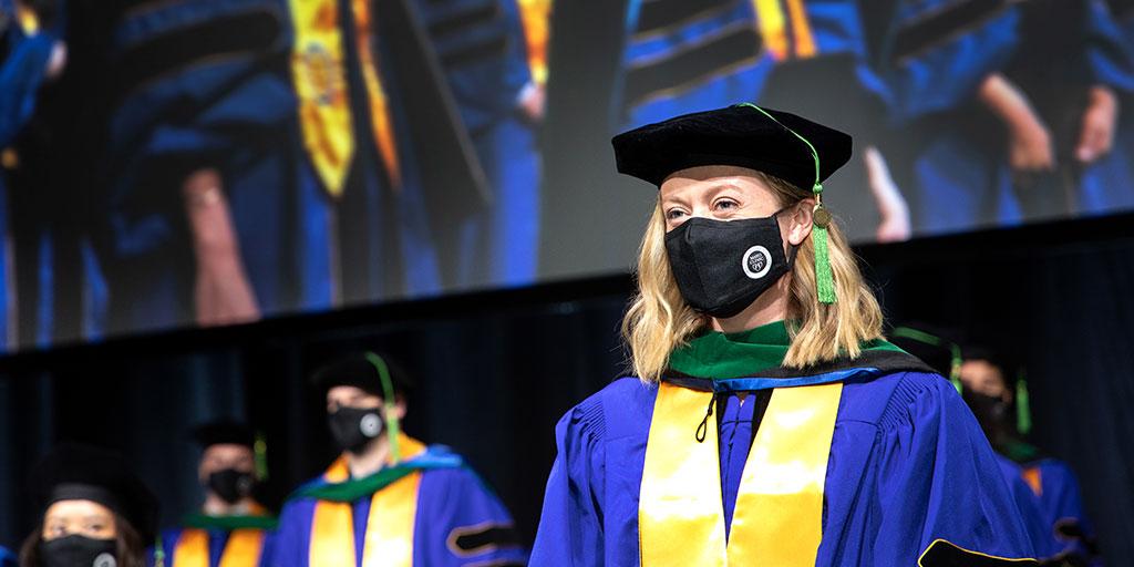 Mayo Clinic Alix School of Medicine student stands with other soon-to-be-graduates at the commencement ceremony