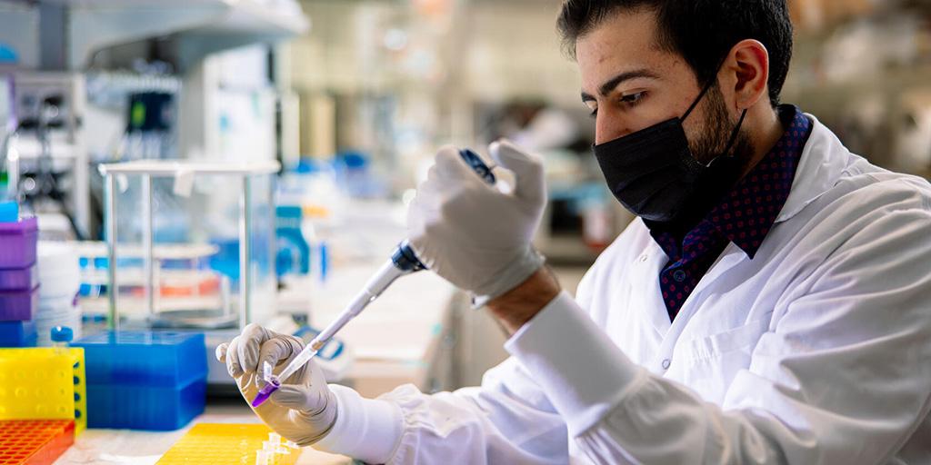 Armin Garmany sets up assay samples with a pipette and microtube in the Marriott Heart Disease Lab