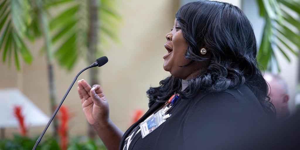 Mayo Clinic employee sings at a MERG gathering.