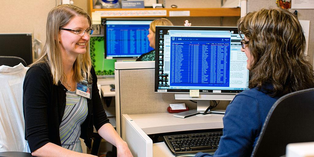 Mayo Clinic health information managers sitting by a computer