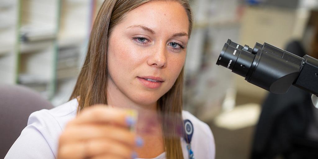 A Mayo Clinic cytotechnologist observing a slide