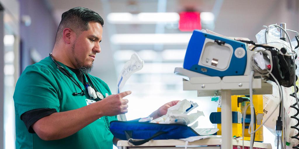 Respiratory therapist removing an endotracheal tube from an airway roll kit
