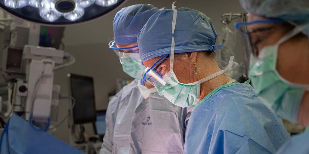 Gynecology PA fellow and faculty performing surgery in the operating room