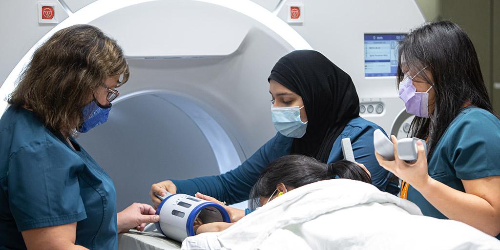 Nourhan Halawa and Quyen Nguyen are instructed by Jennifer Myers in Magnetic Resonance Imaging (MRI) techniques at Mayo Clinic in Rochester, Minnesota.