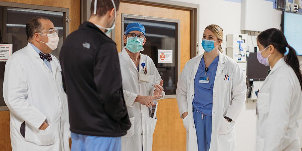 Health care team standing in a group in a hallway