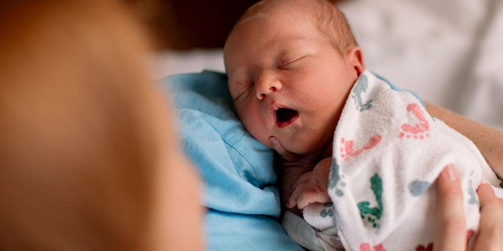 Close-up photo of a newborn baby being held