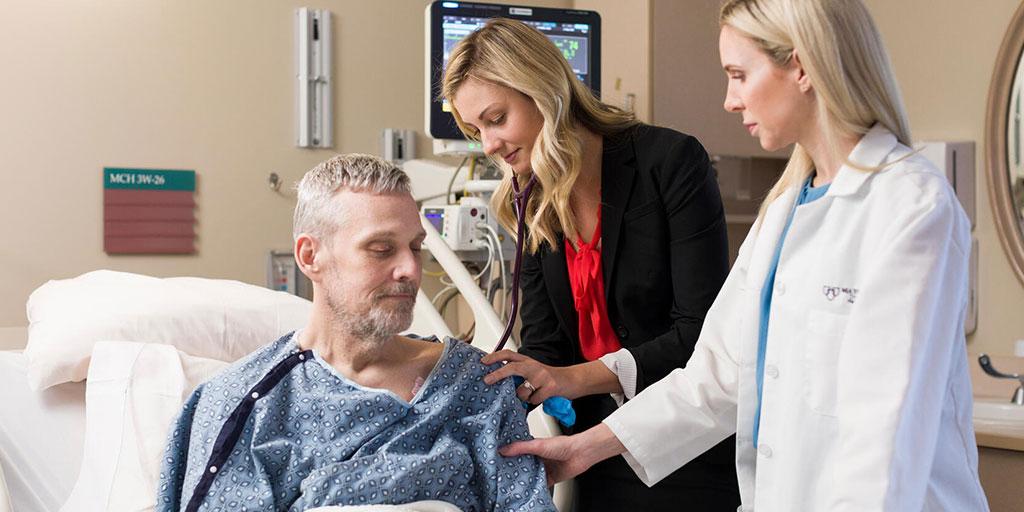 Two fellows in the NPPA Abdominal Organ Transplant Fellowship performing exam in an exam room