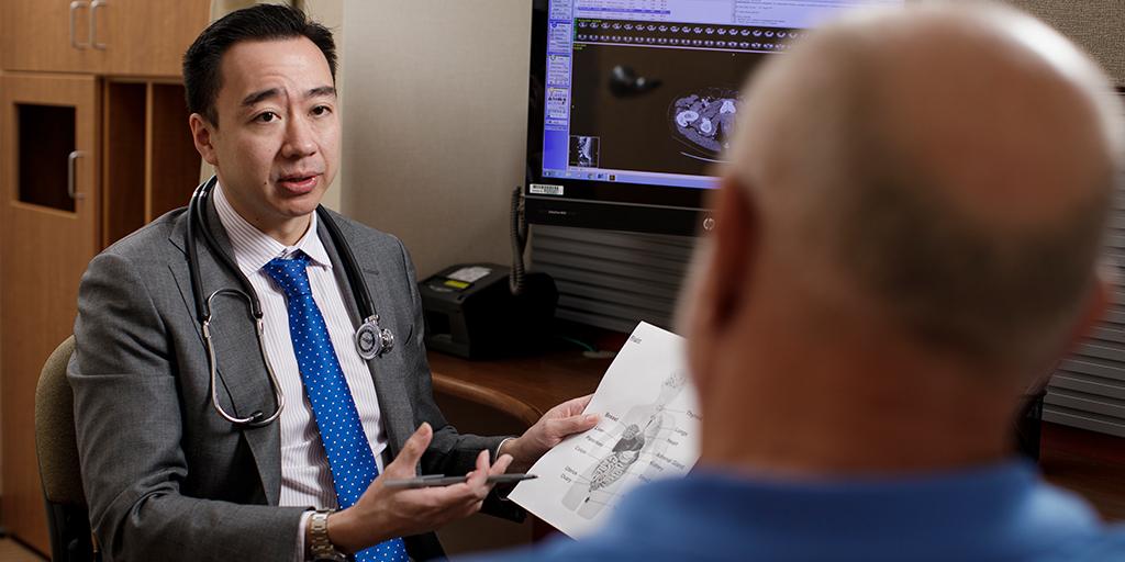 Nurse practitioner or physician assistant specializing in hematology or medical oncology explaining something to patient