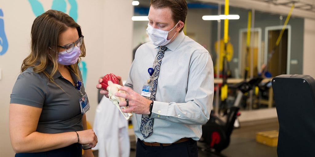 Hillaree Leif, P.T., D.P.T,. and Justin Wilcox, P.A.-C., discuss physical therapy and sports medicine using an anatomical model at Mayo Clinic in Phoenix, Arizona..