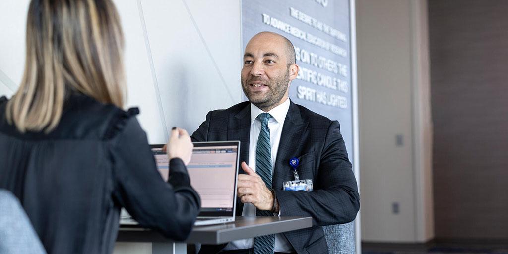 Residents in the Solid Organ Transplant Pharmacy Residency at Mayo Clinic in Arizona sit at a table and discuss a patient