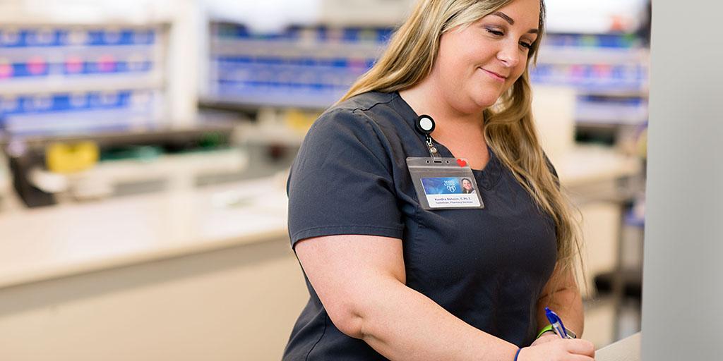 Pharmacy technician working on medication inventory