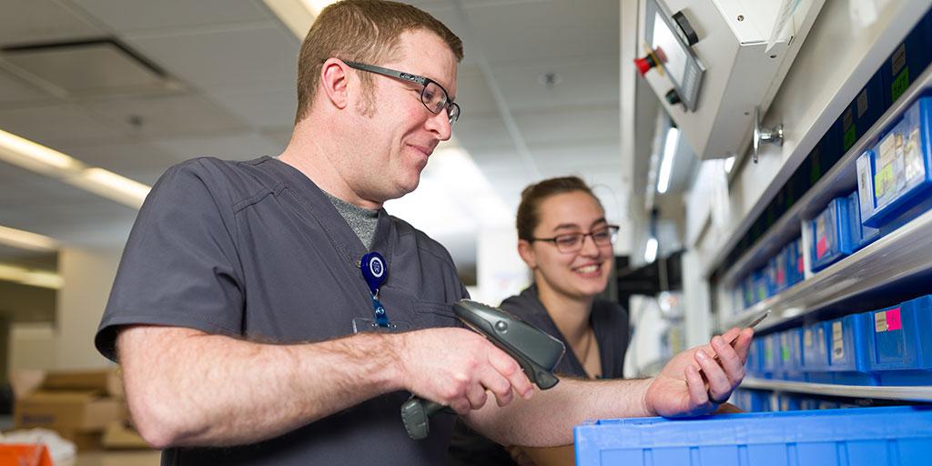 Pharmacy residents sorting through medications in a lab