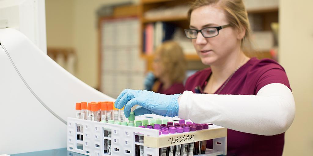 A Mayo Clinic phlebotomist technician working with a patient