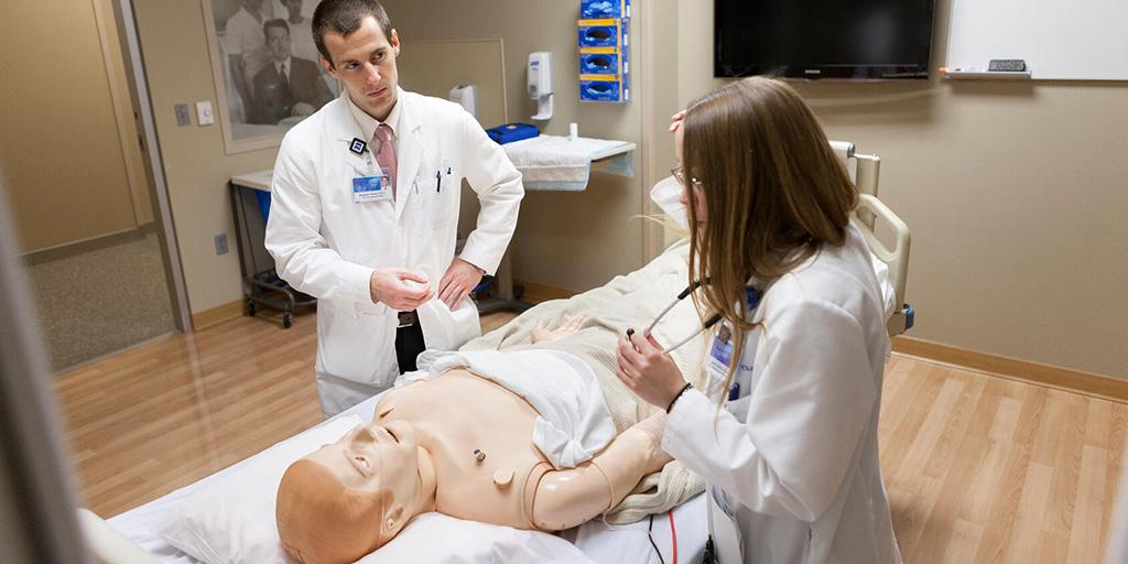 Physician assistants in hospital internal medicine examine a patient in a simulated situation