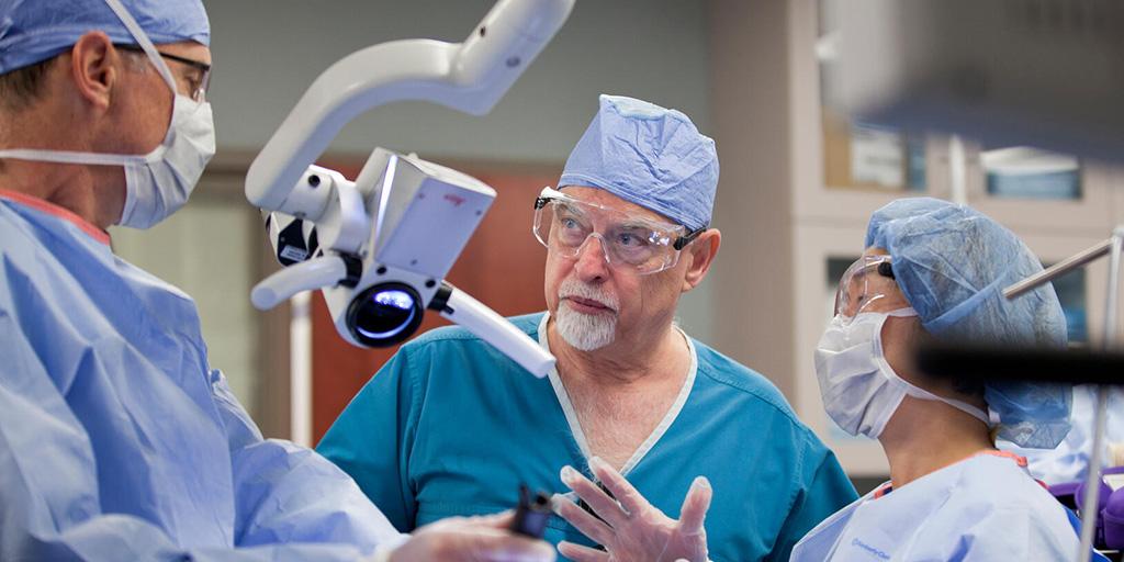 Surgeons in the OR working on transoral approaches in head and neck surgery.