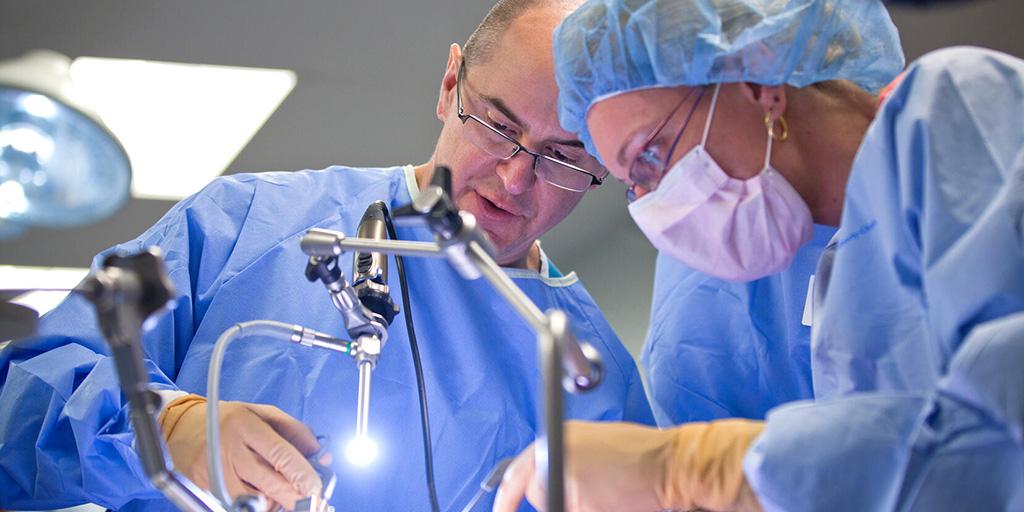 Surgeons in the OR working on transoral approaches in head and neck surgery.