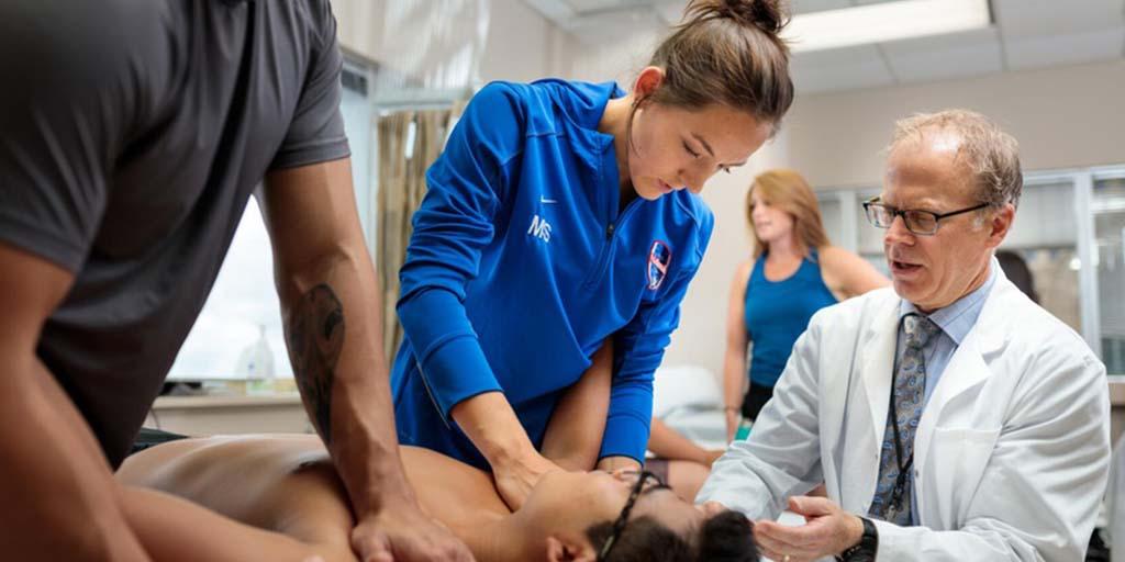 PT resident performing a shoulder mobilization exercise.