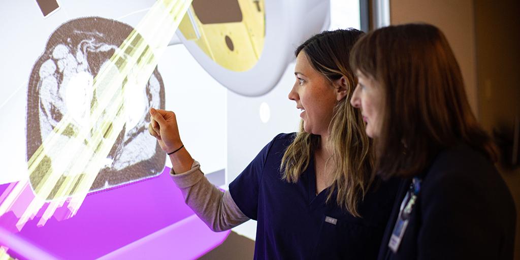 Student and faculty member using a VERT classroom learning tool as part of the curriculum for the Radiation Therapy Program for training to become a radiation therapist. 