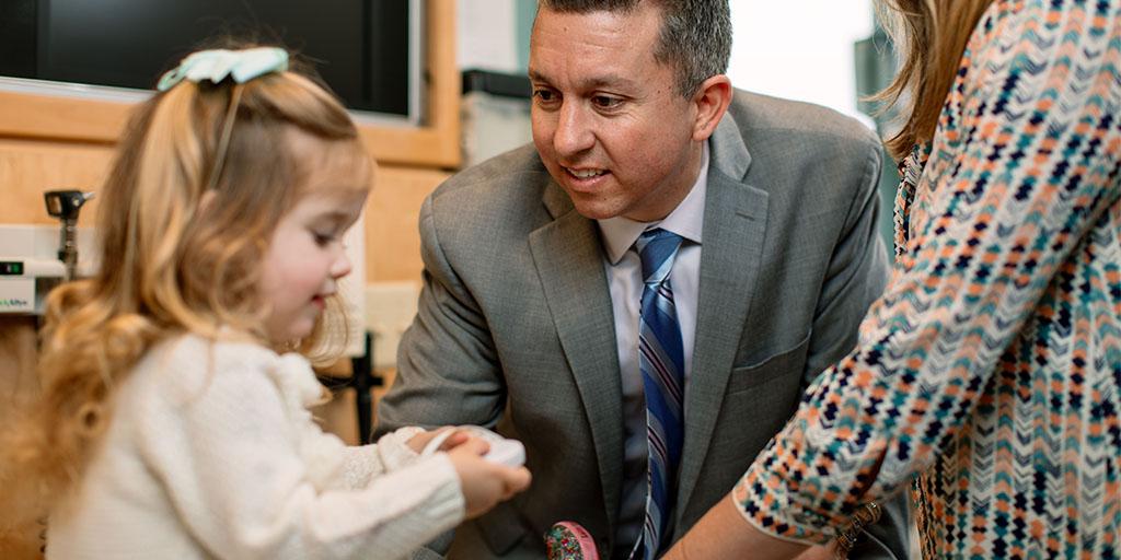 Social worker working with child and family during clinical visit